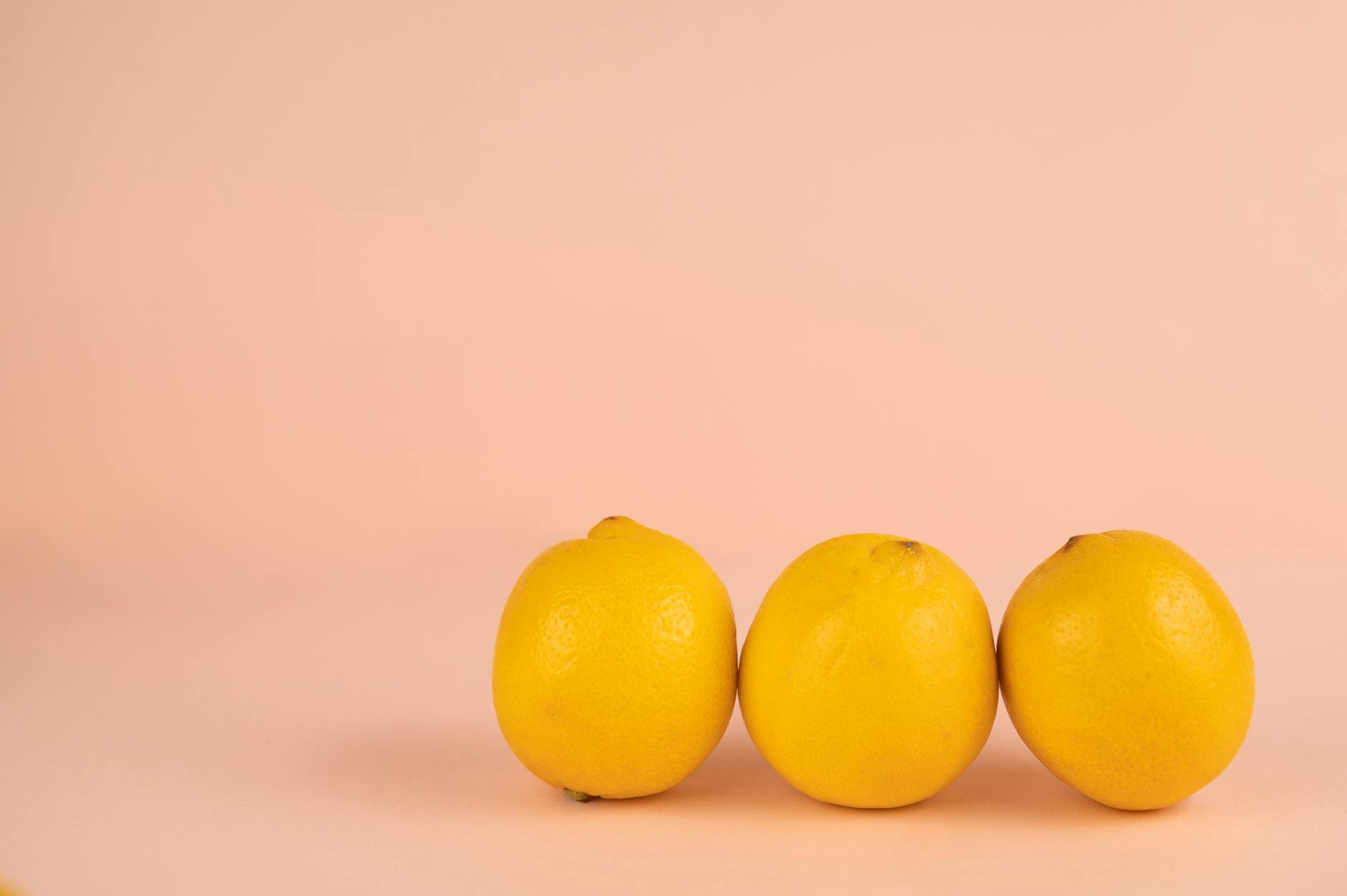 Bright ripe lemons on a soft pastel background, symbolizing fresh approaches to intimacy